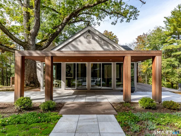 a front view of a house with a garden