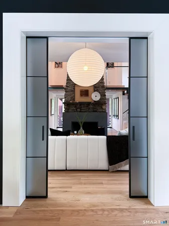 a living room with furniture a mirror and a fireplace