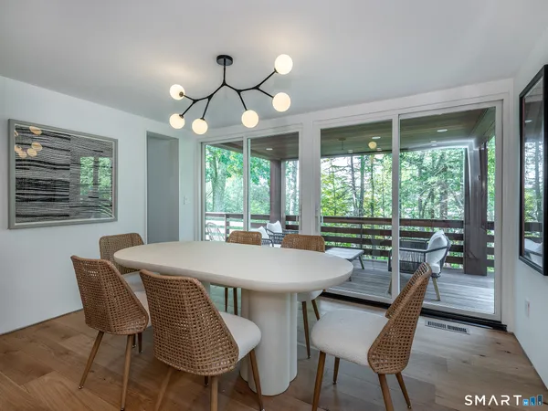 a view of a dining room with furniture wooden floor and chandelier