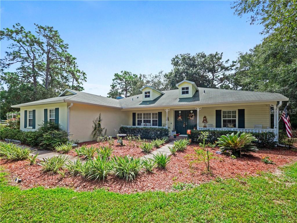 peaceful front porch and clean curb appeal is complete with fresh paint, new light fixtures, irrigation