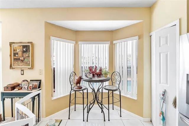 a view of a dining room with furniture and a window