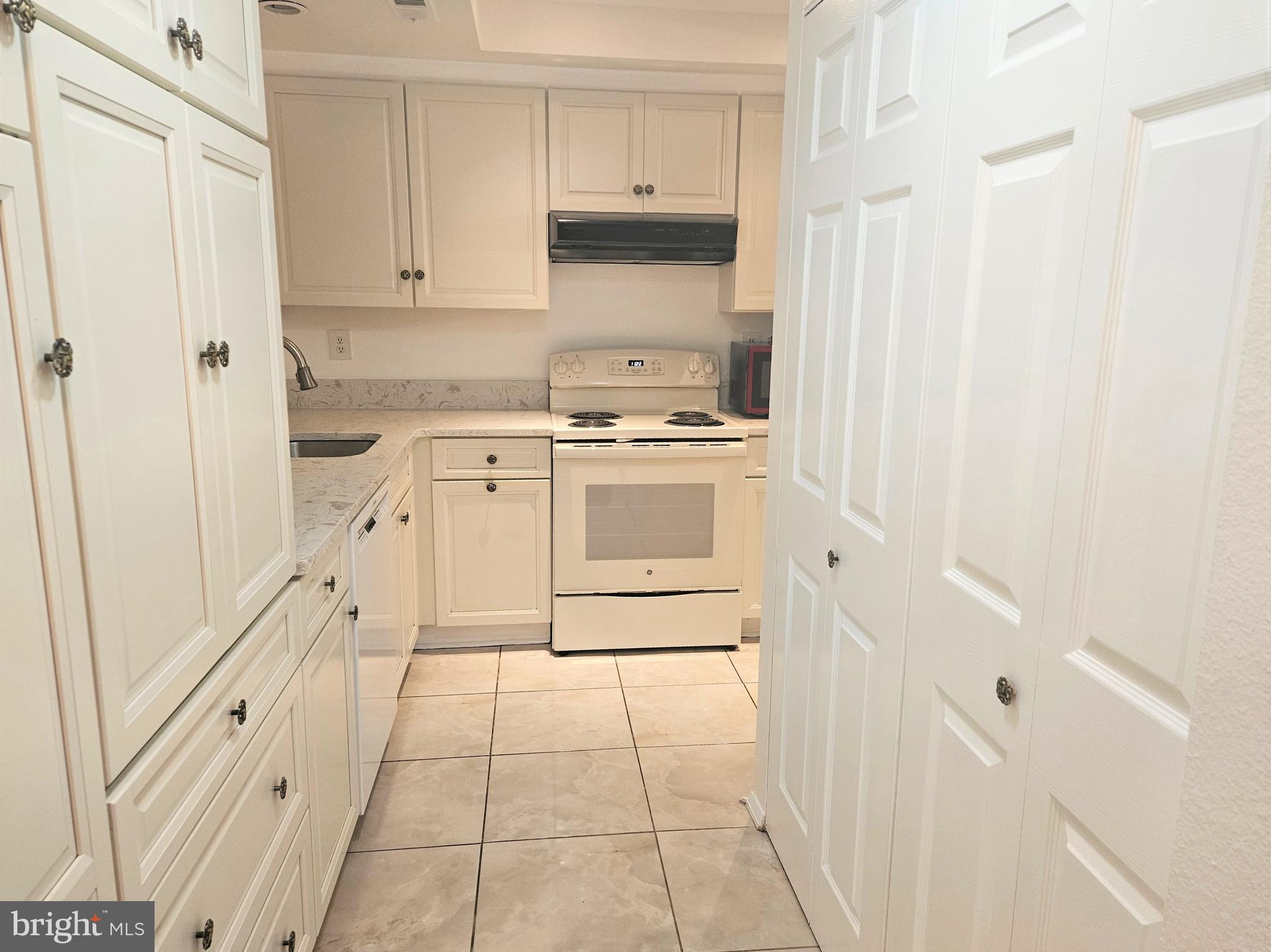 3501 Forest Edge Drive, Unit 141E Silver Spring, MD 20906 - Photo 14 of 27 Kitchen Storage and Laundry Closet