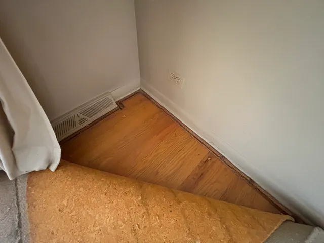 a view of a room with a bed