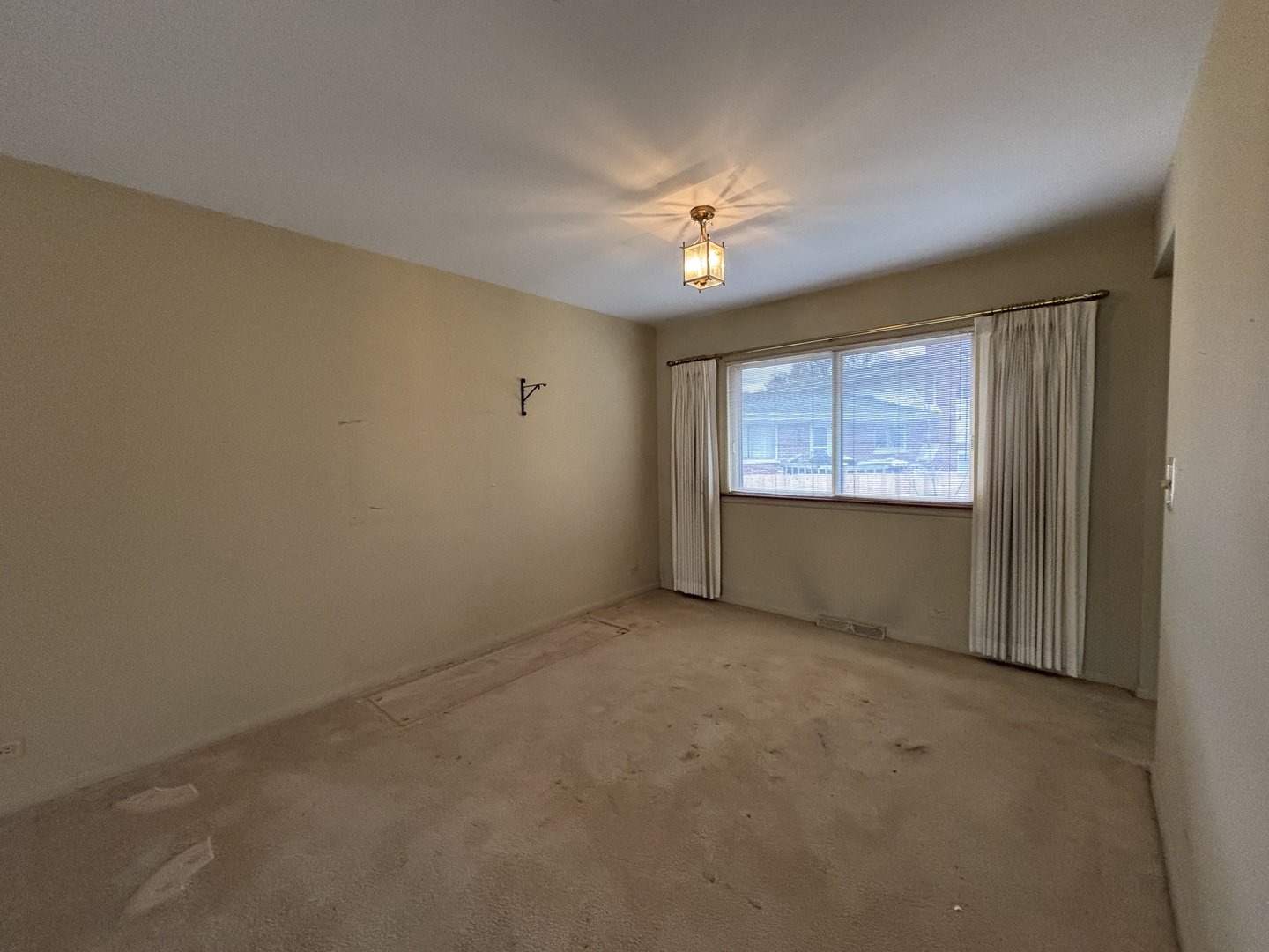 1305 West Mulberry Lane Arlington Heights, IL 60005 - Photo 4 of 14 an empty room with windows and chandelier fan