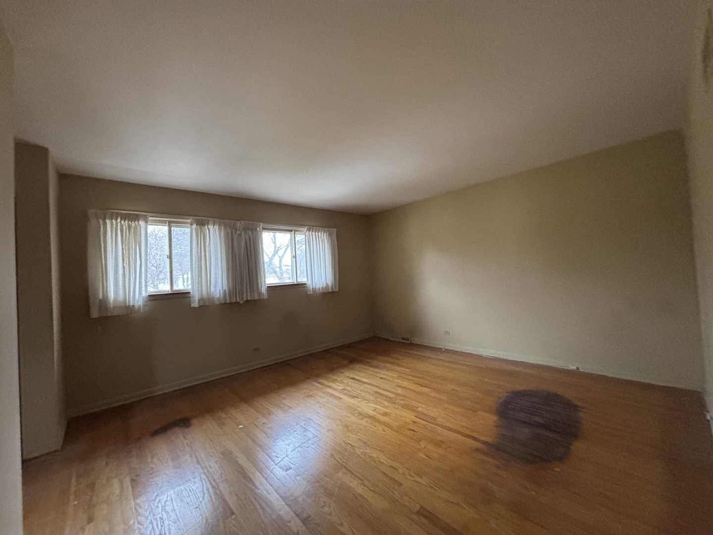 1305 West Mulberry Lane Arlington Heights, IL 60005 - Photo 10 of 14 a view of an empty room with wooden floor and a window
