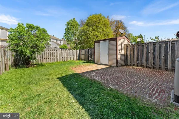 a view of a backyard with wooden fence
