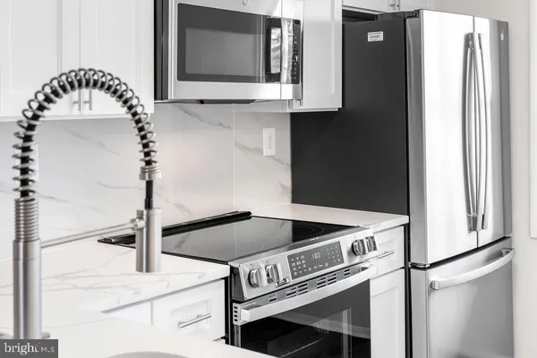 a kitchen with a microwave and a sink