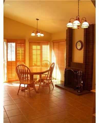 Another photo of the LARGE dinette area with fireplace.  Sellers have high end HUNTER ceiling fans in several locations which keep the cool, coastal breezes flowing!