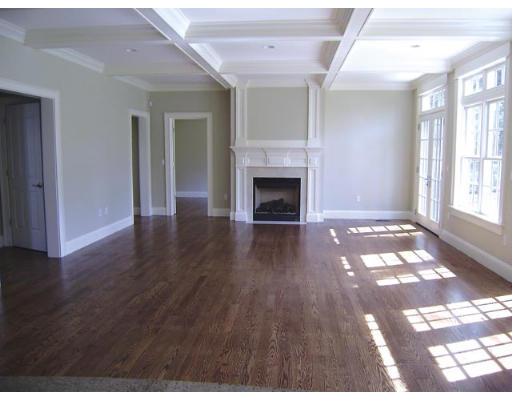 53 Valley Road Brookline, MA 02467 - Photo 4 of 5 a view of an empty room with wooden floor fireplace and a window
