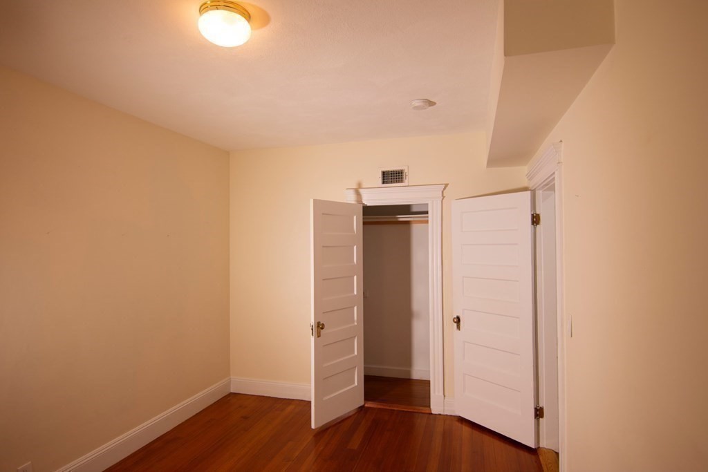 1897 Beacon Street, Unit 3 Brookline, MA 02445 - Photo 11 of 18 a view of empty room with wooden floor