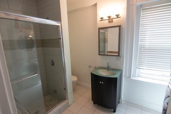 1897 Beacon Street, Unit 3 Brookline, MA 02445 - Photo 15 of 18 a bathroom with a sink toilet and shower