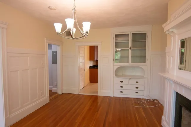 wooden floor in an empty room with a fireplace