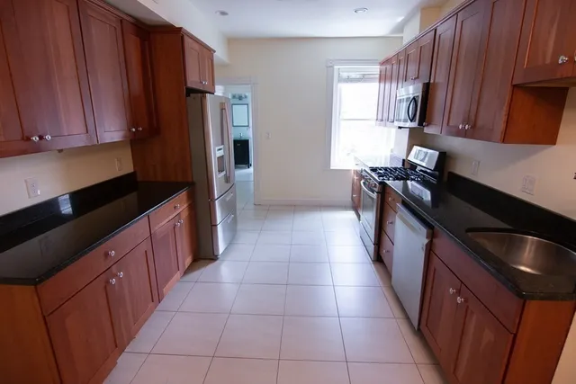 a kitchen with a refrigerator stove and cabinets