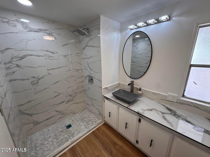 303 South Recker Road, Unit 50 Mesa, AZ 85206 - Photo 5 of 6 a bathroom with a sink a mirror and shower