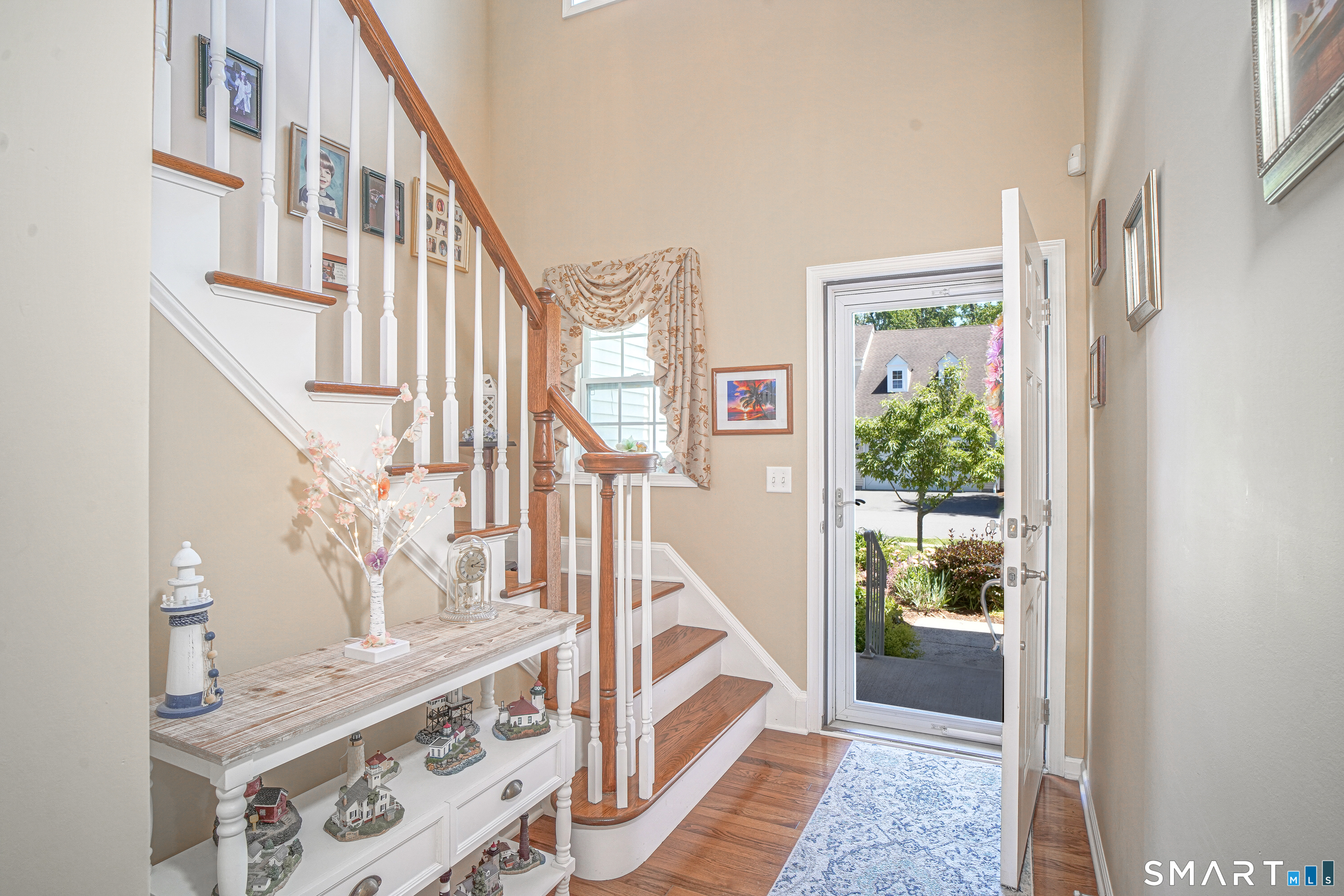 6 Lilac Lane, Unit 6 Prospect, CT 06712 - Photo 4 of 40 Greet your guest in the 2 story foyer with hardwood floors and an open stair railing to the upper level.