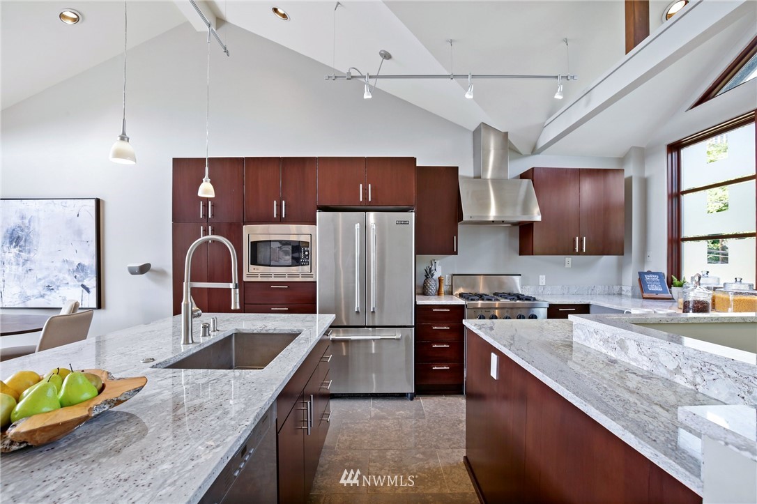 423 Ward Street Seattle, WA 98109 - Photo 11 of 39 a kitchen with stainless steel appliances granite countertop a sink stove and refrigerator
