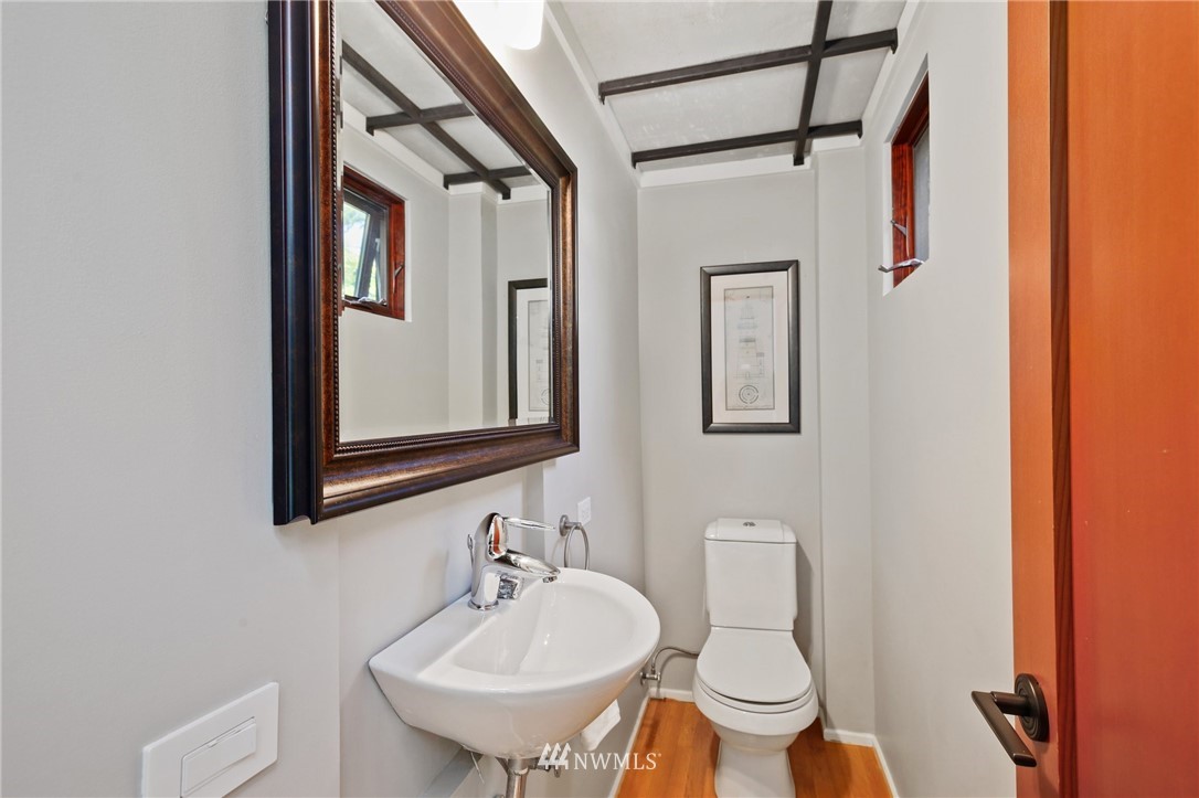 423 Ward Street Seattle, WA 98109 - Photo 18 of 39 a bathroom with a toilet sink and mirror