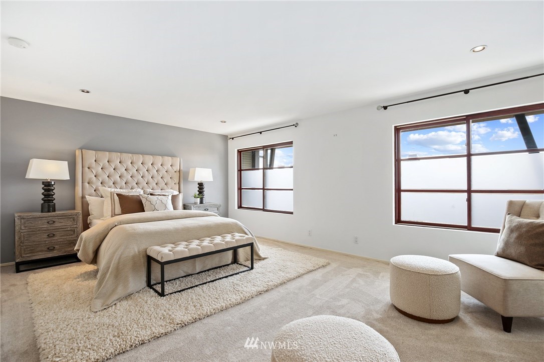 423 Ward Street Seattle, WA 98109 - Photo 27 of 39 a spacious bedroom with a bed and a large window