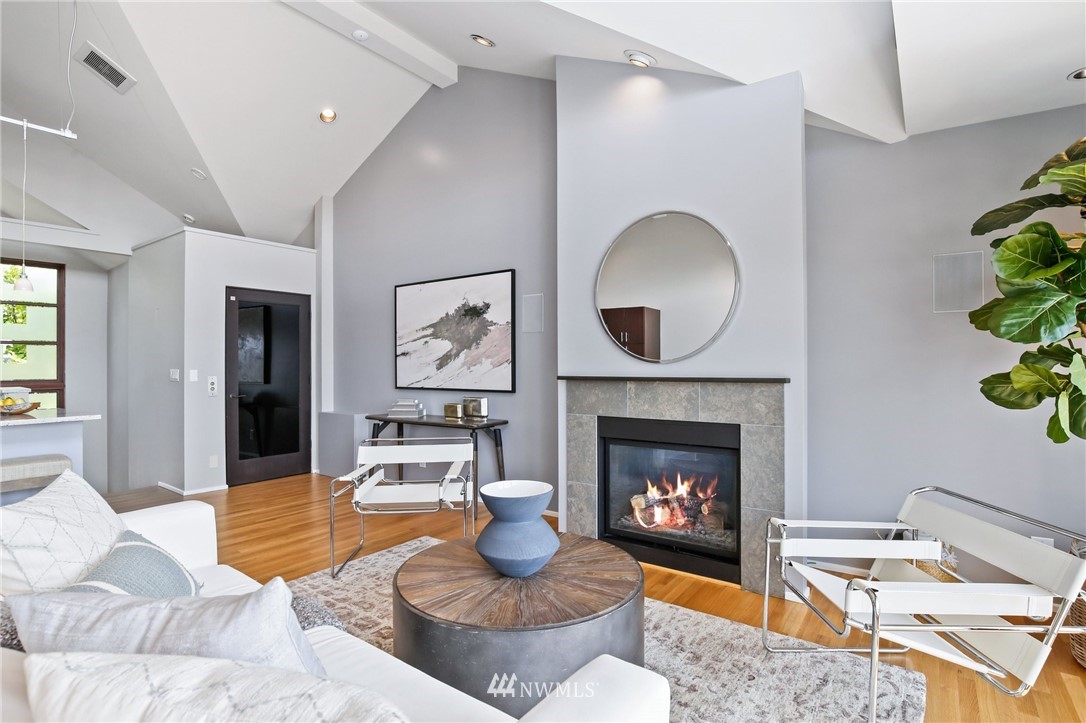 423 Ward Street Seattle, WA 98109 - Photo 5 of 39 a living room with furniture and a fireplace