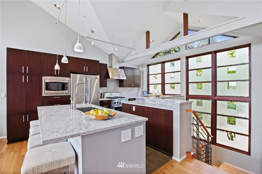 423 Ward Street Seattle, WA 98109 - Photo 10 of 39 a kitchen with stainless steel appliances granite countertop a stove and a refrigerator