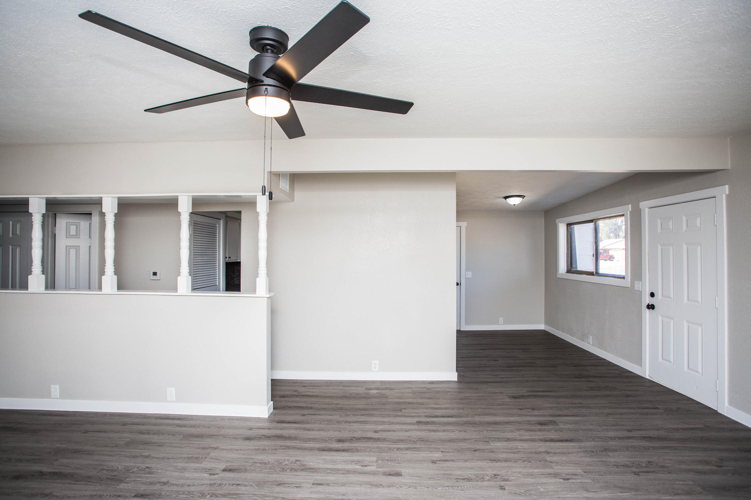 2725 63rd Street Lubbock, TX 79413 - Photo 11 of 41 a view of an empty room with wooden floor and a ceiling fan