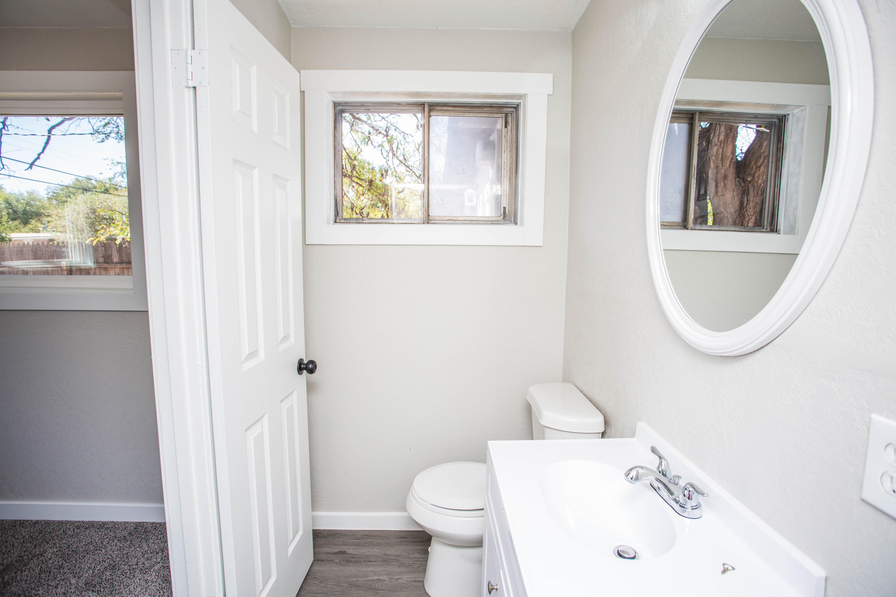 2725 63rd Street Lubbock, TX 79413 - Photo 23 of 41 a bathroom with a sink a toilet and a mirror