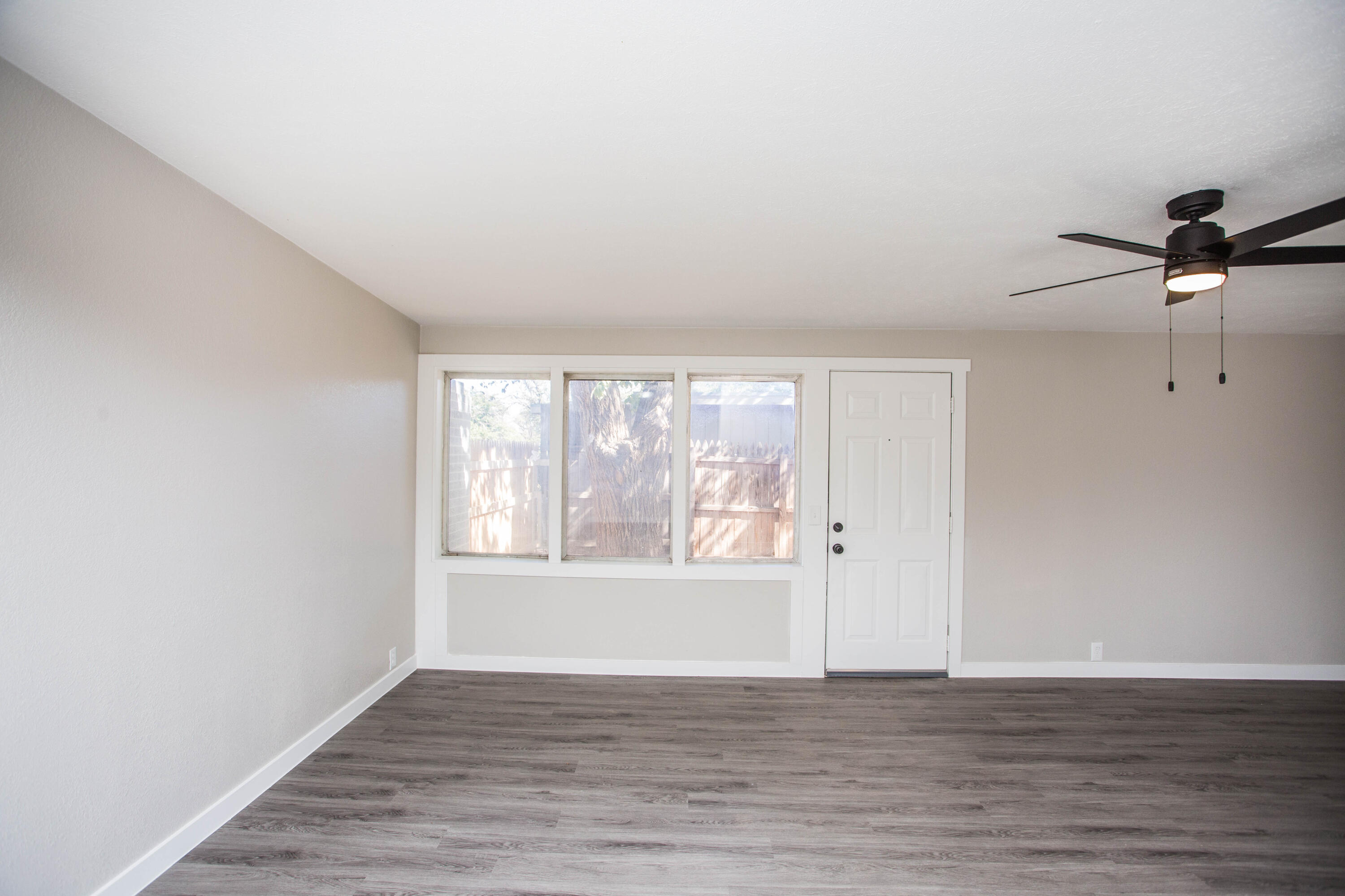 2725 63rd Street Lubbock, TX 79413 - Photo 9 of 41 a view of an empty room with wooden floor and a window