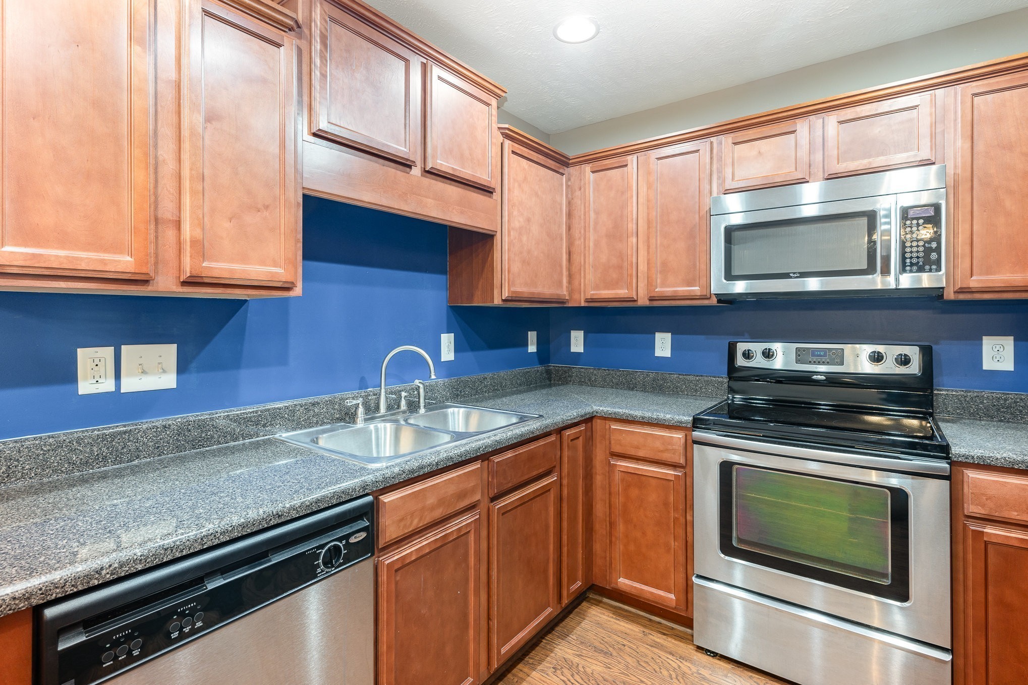 3065 Soaring Eagle Way Spring Hill, TN 37174 - Photo 10 of 18 a kitchen with stainless steel appliances granite countertop a sink stove and microwave