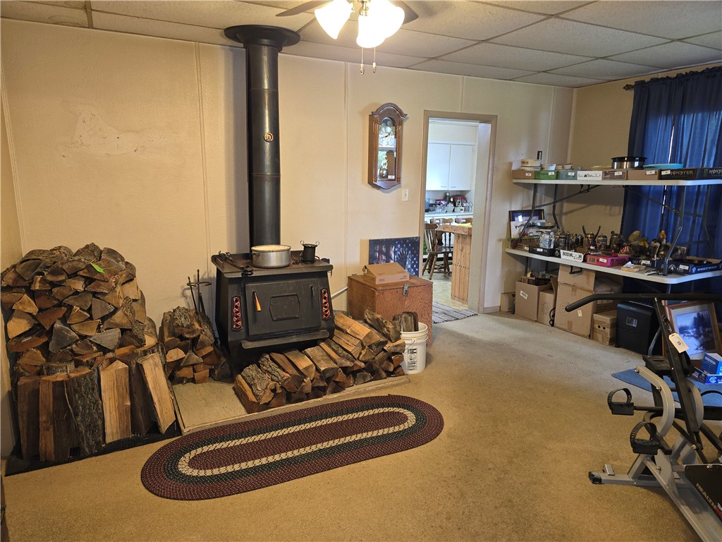 457 Wolf Road West Alexandria, OH 45381 - Photo 15 of 28 This inviting living space features a cozy wood-burning stove, creating a warm and rustic ambiance.