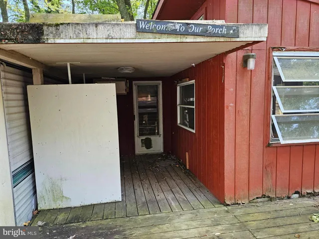 a view of balcony with wooden floor and fence