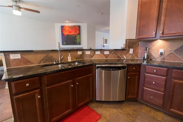 a kitchen with stainless steel appliances granite countertop a sink stove and cabinets