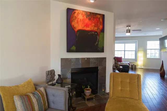 a living room with furniture a flat screen tv and a fireplace