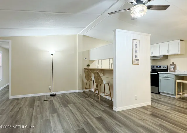 a view of a kitchen with a sink cabinets and wooden floor