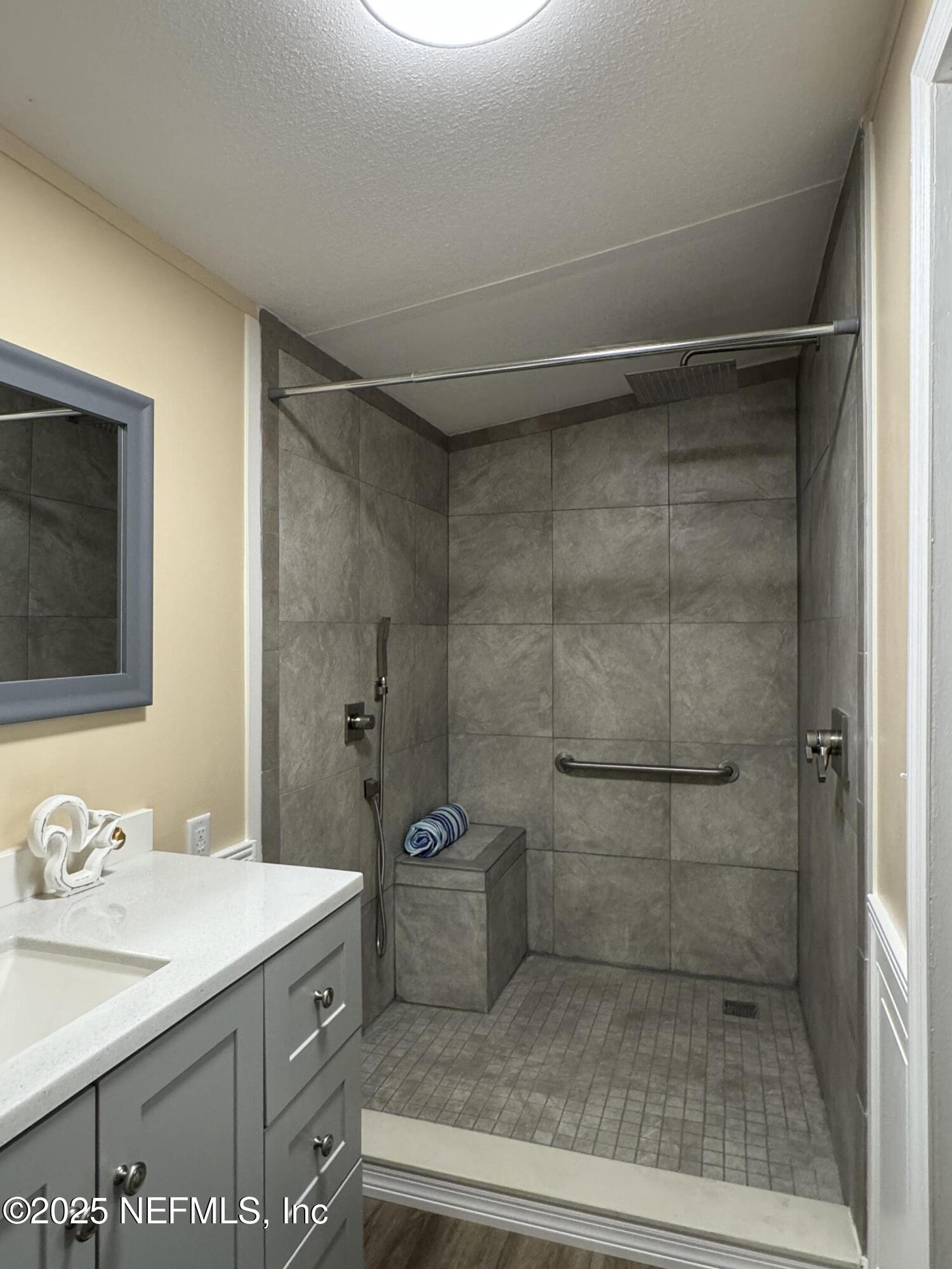106 Ridgewood Avenue Interlachen, FL 32148 - Photo 8 of 23 a bathroom with a granite countertop sink a toilet and shower