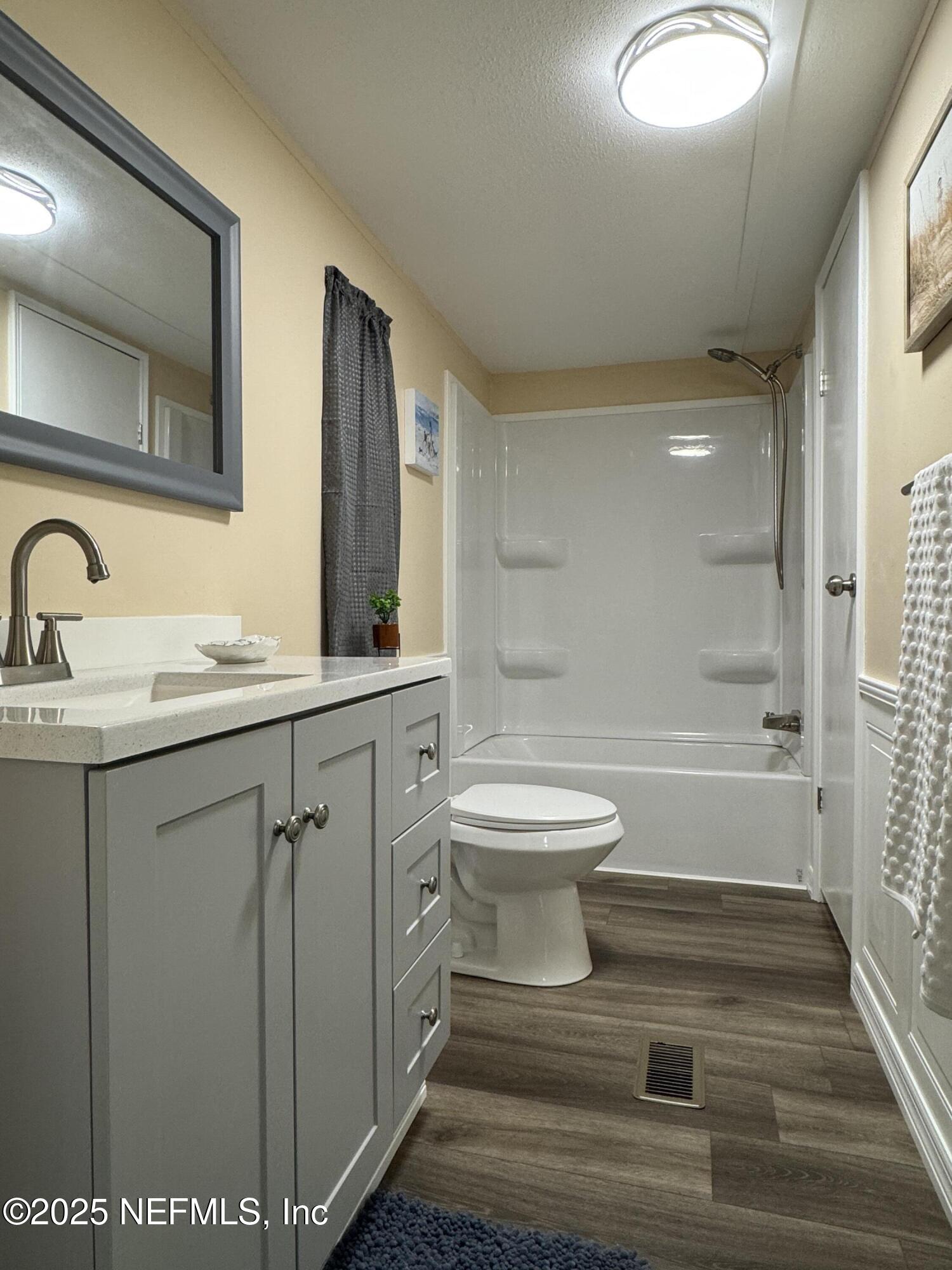 106 Ridgewood Avenue Interlachen, FL 32148 - Photo 10 of 23 a bathroom with a sink a toilet and shower