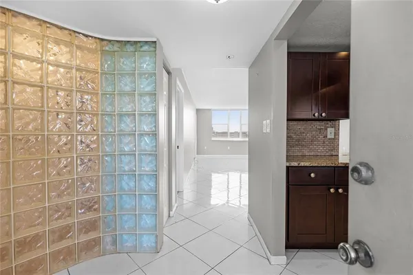 a kitchen with stainless steel appliances granite countertop a refrigerator a sink a stove top oven and a refrigerator