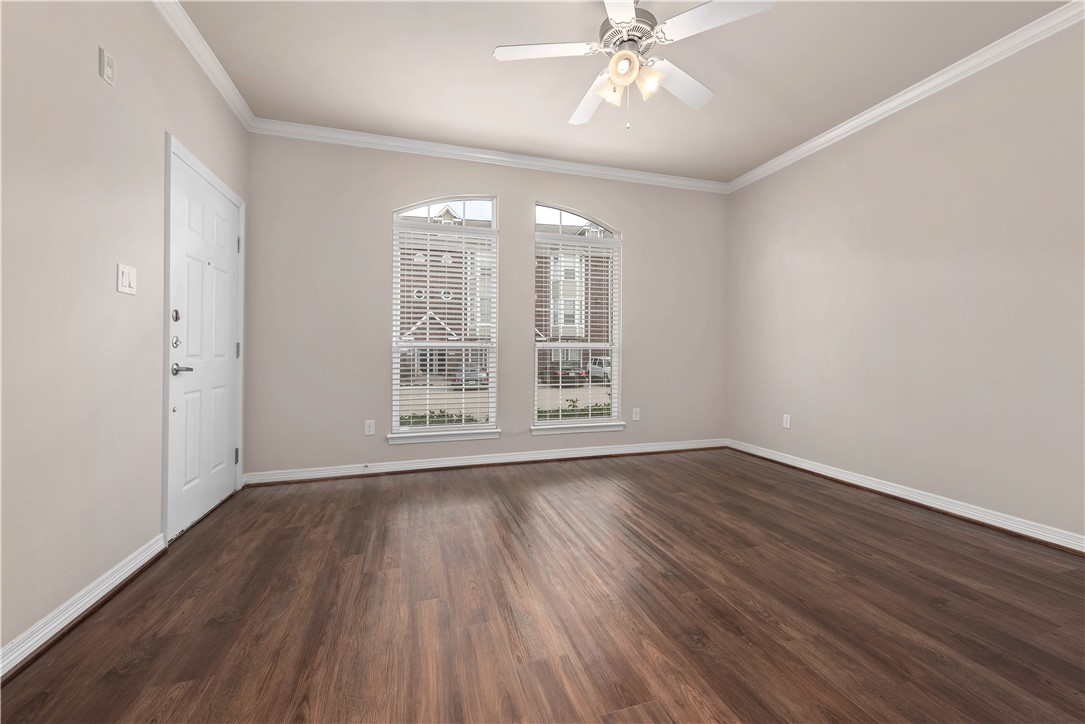 1198 Jones-Butler Road, Unit 1908 College Station, TX 77840 - Photo 6 of 16 Unfurnished room with ornamental molding, dark wood-style floors, and a ceiling fan