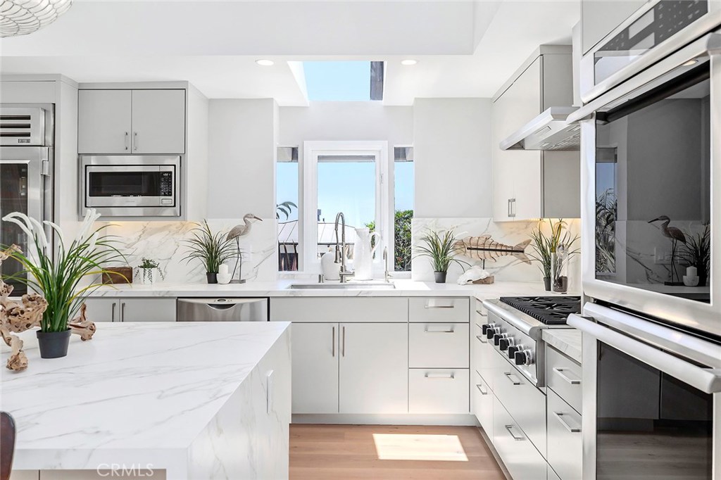 2526 Monaco Drive Laguna Beach, CA 92651 - Photo 11 of 59 a bathroom with cabinets a sink a potted plant and a window