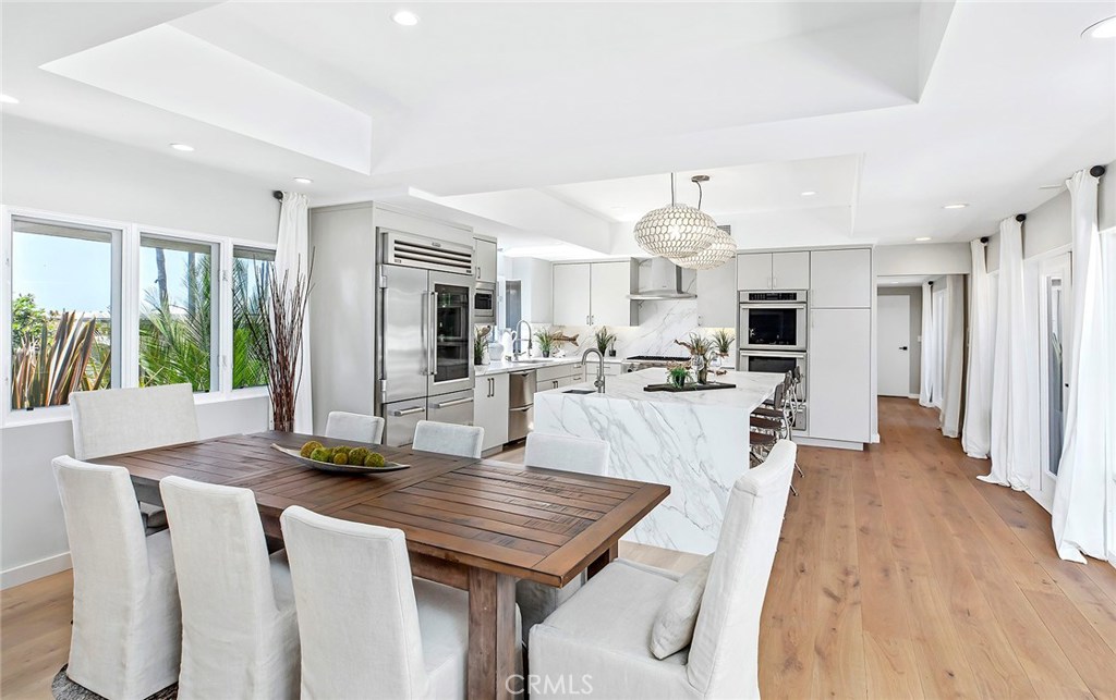 2526 Monaco Drive Laguna Beach, CA 92651 - Photo 13 of 59 a kitchen with stainless steel appliances kitchen island granite countertop a table chairs and a refrigerator