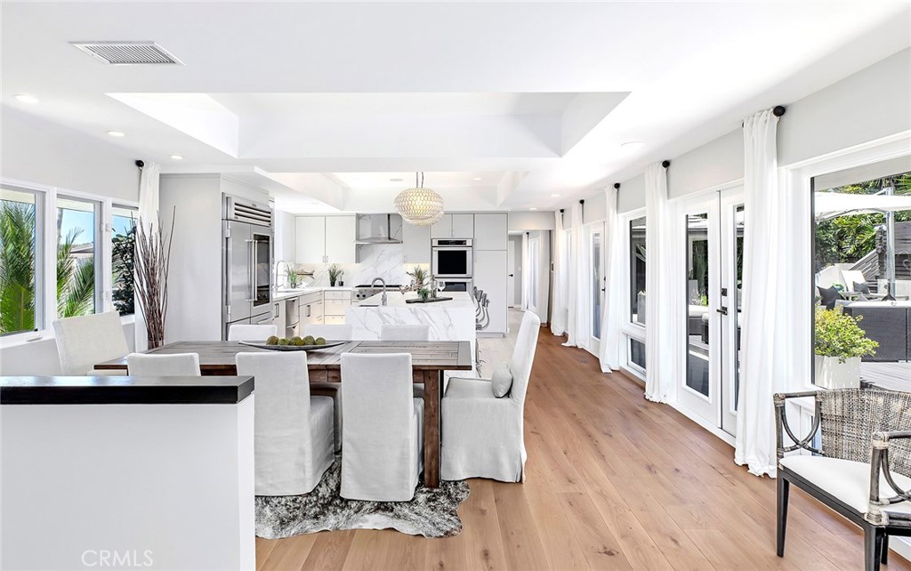 2526 Monaco Drive Laguna Beach, CA 92651 - Photo 14 of 59 a kitchen with stainless steel appliances kitchen island granite countertop a refrigerator a stove a sink dishwasher and white cabinets with wooden floor