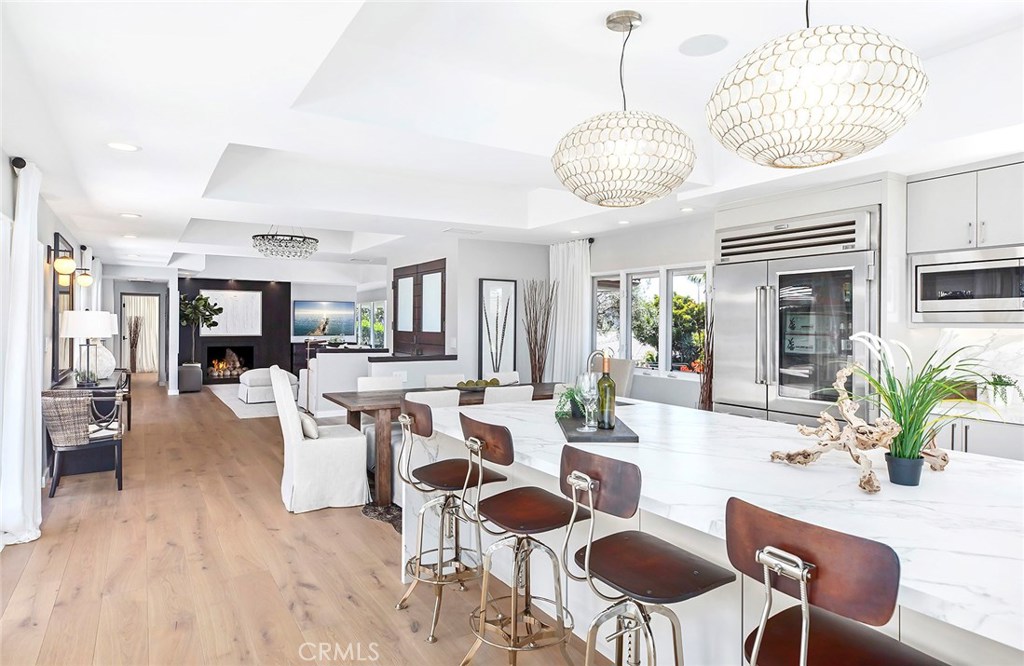 2526 Monaco Drive Laguna Beach, CA 92651 - Photo 16 of 59 a view of a dining room with furniture wooden floor and chandelier