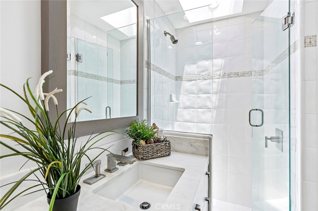 2526 Monaco Drive Laguna Beach, CA 92651 - Photo 32 of 59 a bathroom with a shower a sink and a mirror