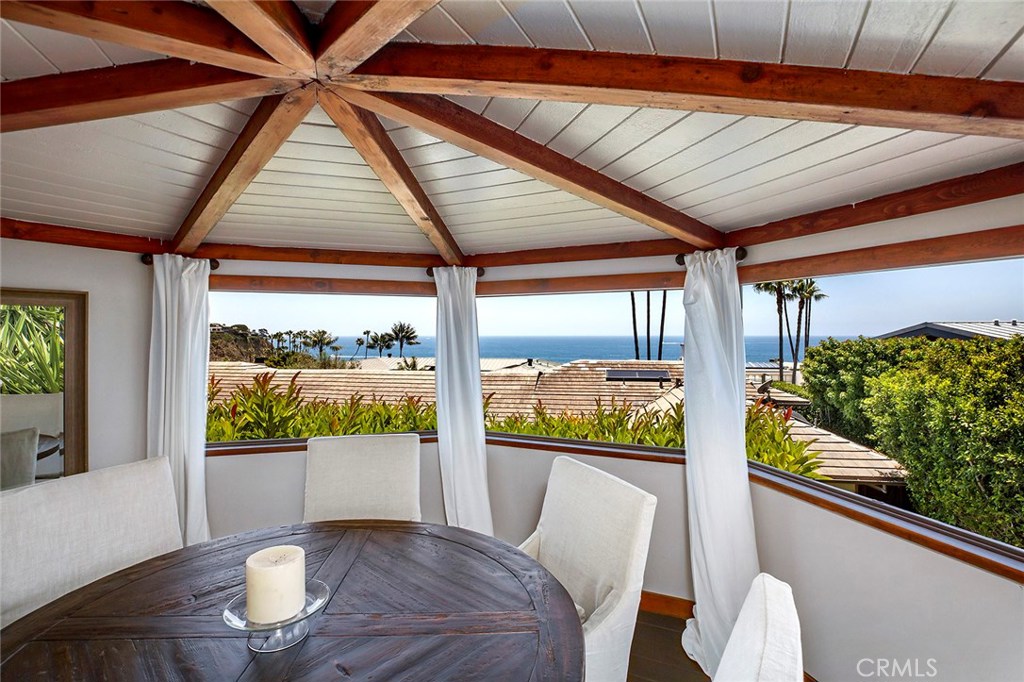 2526 Monaco Drive Laguna Beach, CA 92651 - Photo 4 of 59 a living room with large windows and furniture