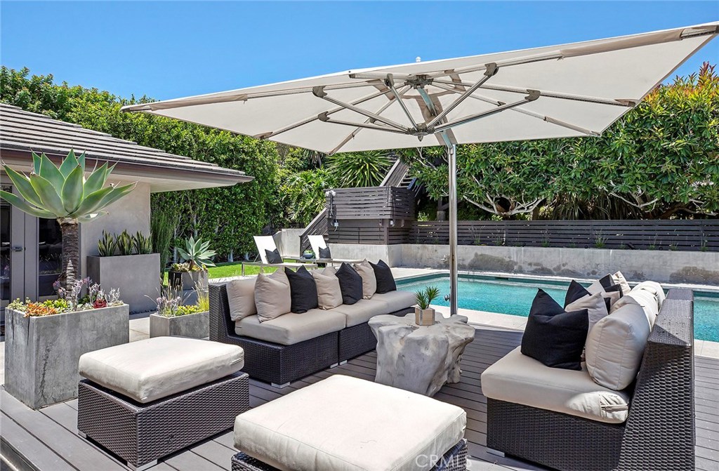 2526 Monaco Drive Laguna Beach, CA 92651 - Photo 41 of 59 a view of a patio with couches chairs under an umbrella