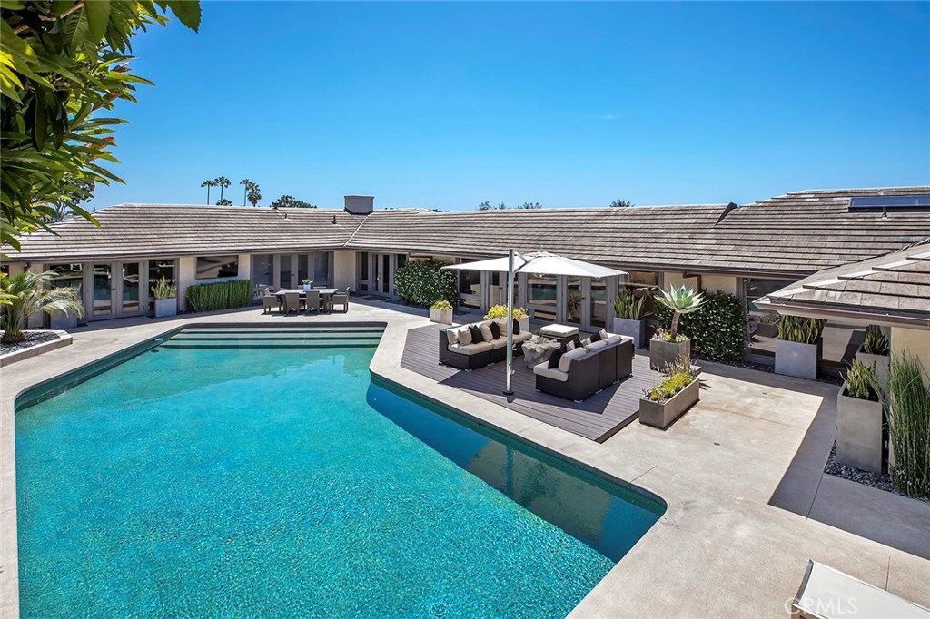 2526 Monaco Drive Laguna Beach, CA 92651 - Photo 5 of 59 a view of a patio with couches table and chairs under an umbrella