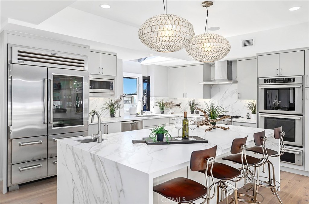 2526 Monaco Drive Laguna Beach, CA 92651 - Photo 9 of 59 a kitchen with stainless steel appliances granite countertop a sink a stove and chairs