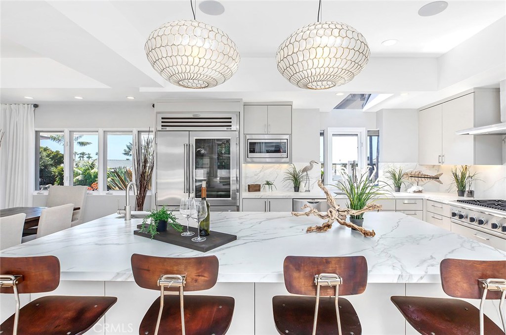 2526 Monaco Drive Laguna Beach, CA 92651 - Photo 10 of 59 a view of a dining room with furniture wooden floor and a chandelier