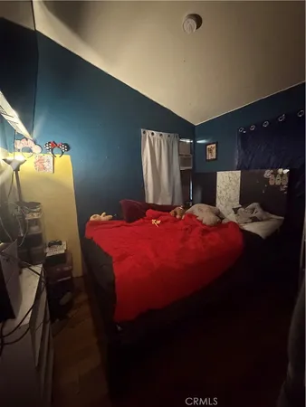 a bedroom with a bed and window