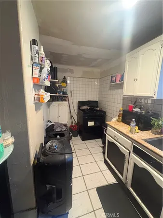 a kitchen with a sink appliances and cabinets