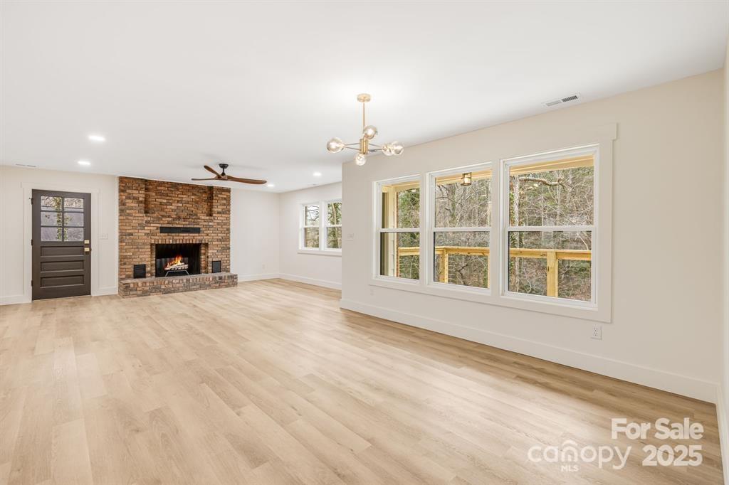 7 Angus Lane Asheville, NC 28805 - Photo 14 of 45 a view of an empty room with a fireplace and a window